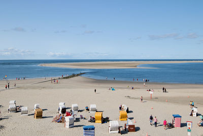 High angle view of people at beach against sky