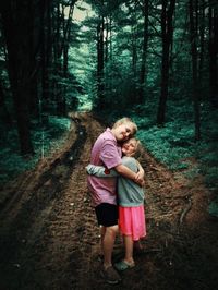 Full length of mother and daughter in forest