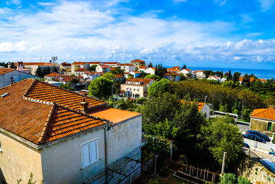 High angle shot of townscape against cloudy sky