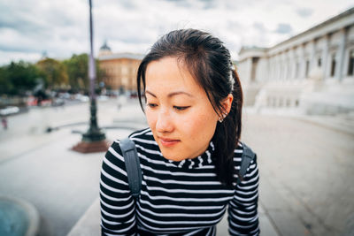 Close-up portrait of young woman in city