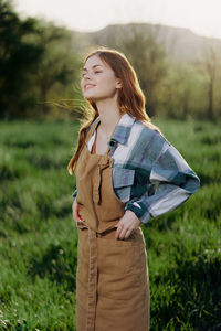 Smiling young woman standing in farm