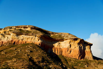 Rock formation against clear blue sky