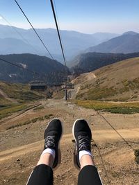 Low section of woman against mountains