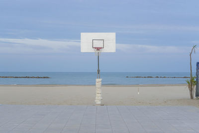 Lifeguard hut on beach against sky