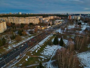 High angle view of road by buildings against sky