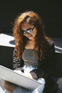 Portrait of young woman using mobile phone