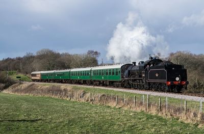 Train on railroad track against sky