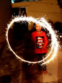 Blurred motion of woman standing at night