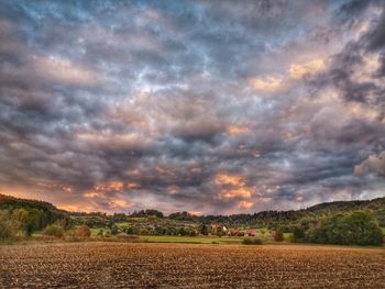 Scenic view of field against sky during sunset