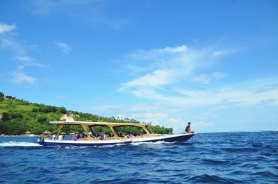 Scenic view of boat in sea against blue sky