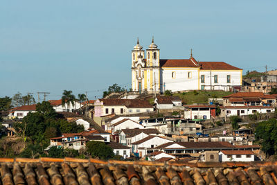 Buildings in town against clear sky