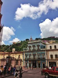 Buildings against cloudy sky