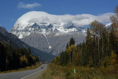 Panoramic shot of road by mountains against sky