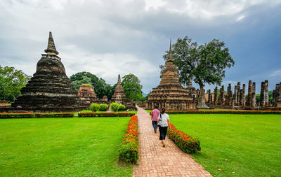 Tourists at temple against building