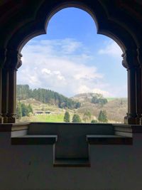 Scenic view of mountains against sky seen through window