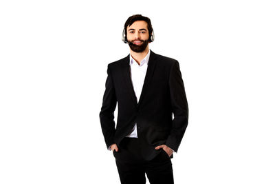 Portrait of young man standing against white background