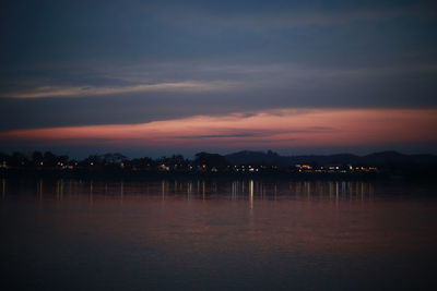 Scenic view of lake against sky at sunset