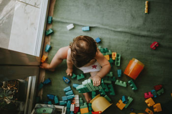 Directly above shot of baby girl playing with toys at home