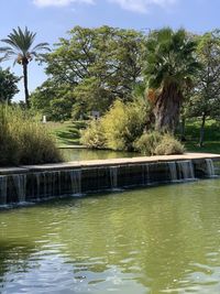 Swimming pool by river against sky