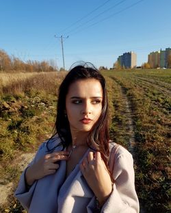 Portrait of beautiful woman lying on land