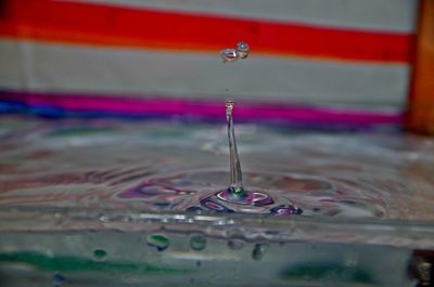 Close-up of drop falling on water surface