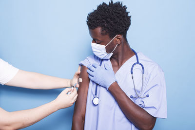 Midsection of doctor examining patient at clinic