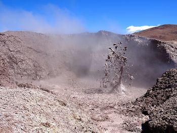 Smoke emitting from volcanic mountain against sky