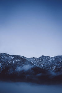 Scenic view of mountains against clear blue sky