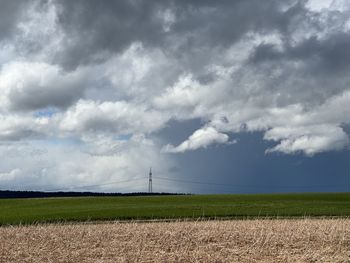 Scenic view of agricultural field against sky