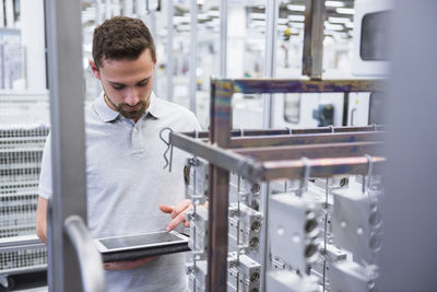 Man using tablet in factory shop floor