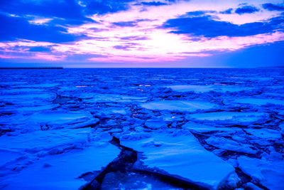 Scenic view of sea against sky during winter