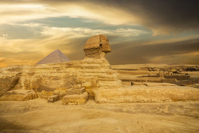 The great sphinx of giza against cloudy sunset sky