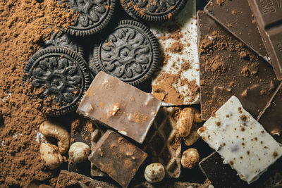 Heap of chocolate, round biscuit with toppings, hazelnuts and cashews. world chocolate day.