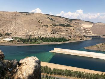 Scenic view of river against cloudy sky