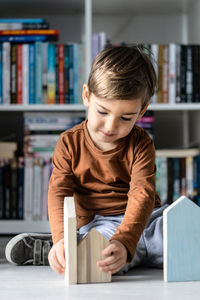 Full length of boy with book on table