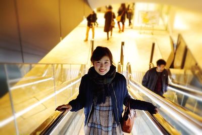 Portrait of young woman walking in shopping mall