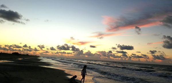 Scenic view of beach against sky during sunset