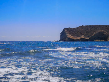 Scenic view of sea against clear blue sky