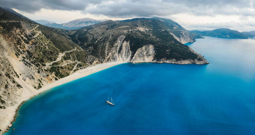 Scenic view of sea and mountains against sky