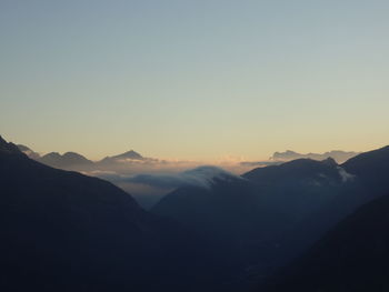 Scenic view of mountains against clear sky during sunset