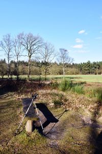 Windmill on field against sky