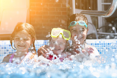 Portrait of happy girls in swimming pool