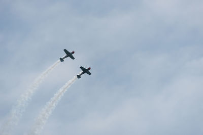 Low angle view of airshow against sky