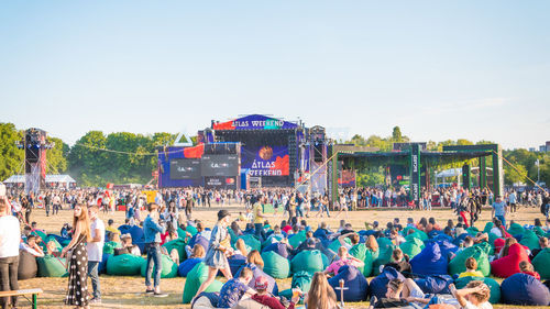 People at music concert against clear sky