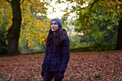 Woman standing at park during autumn