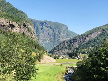 Scenic view of landscape and mountains against clear sky