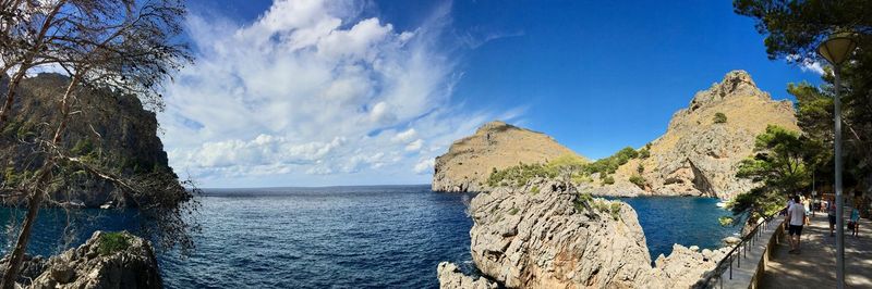 Panoramic view of sea and mountains against sky