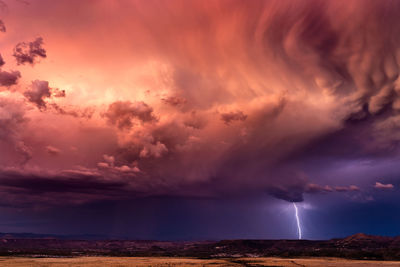 Dramatic sky with storm clouds and lightning at sunset near globe, arizona.