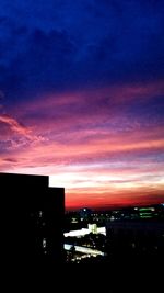 High angle view of illuminated buildings against sky at sunset