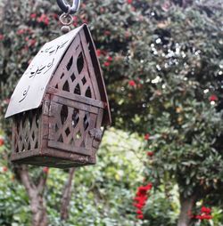 Low angle view of birdhouse against trees